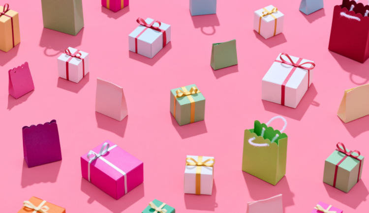 Colorful Gift Boxes Arranged on a Pink Background in Various Sizes