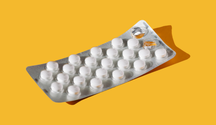 a blister pack of pills against a bright yellow background