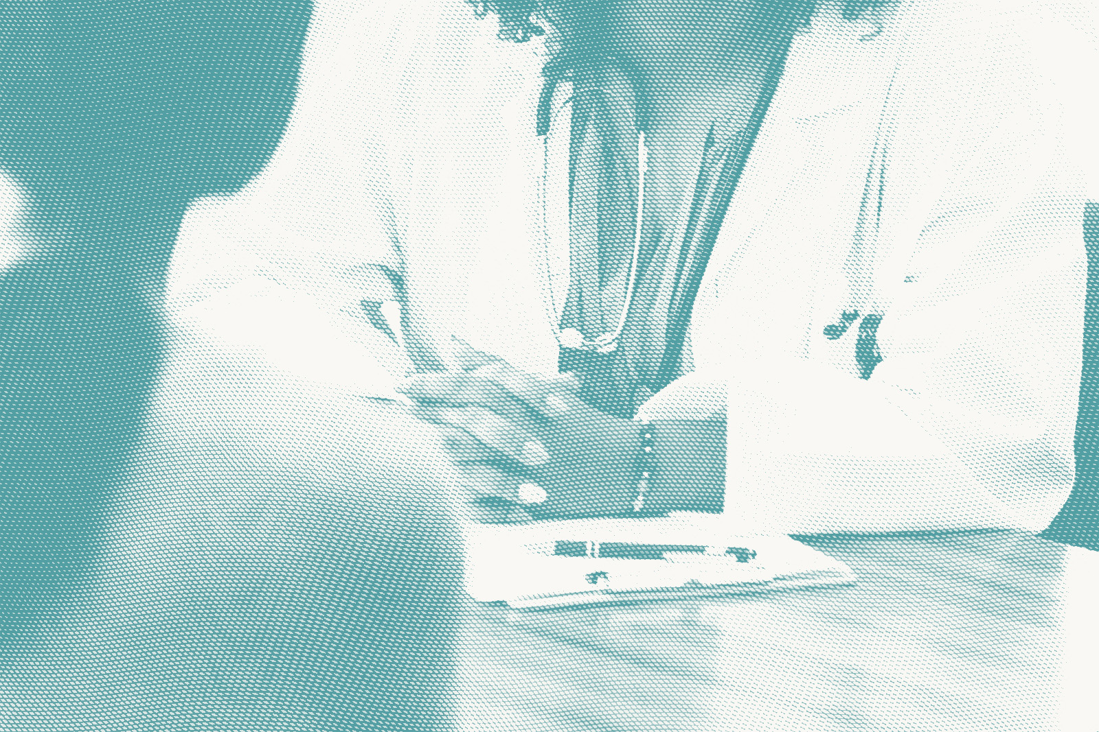 a closeup of a doctor speaking to a patient, we only see their hands and chests at a desk